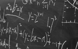 Maths formulas on chalkboard background